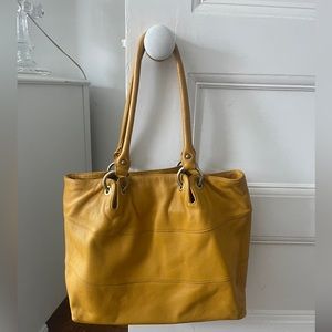 Burnt orange color tote with brass colored hardware